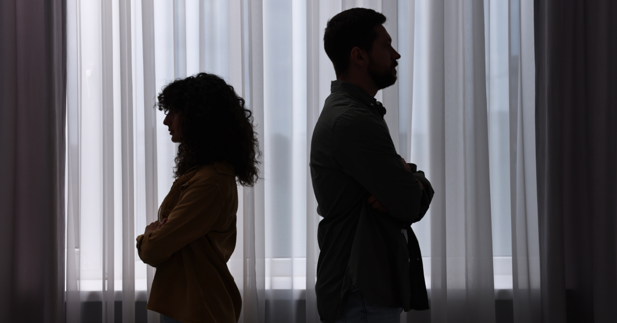 a relationship couple with backs to each other not talking after an argument